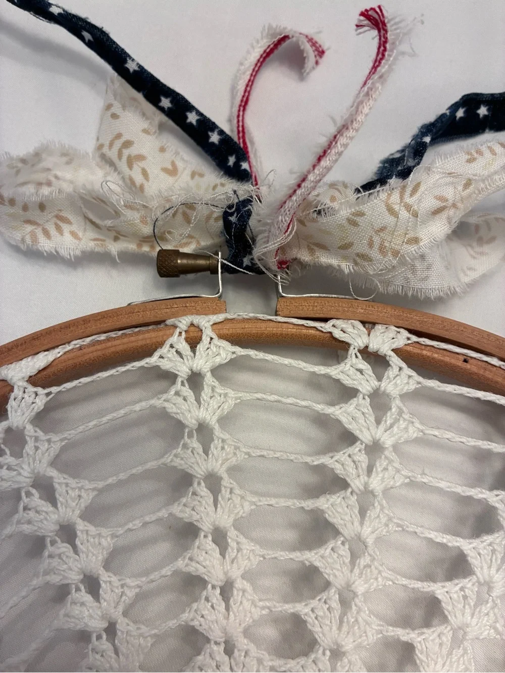 Handmade 10” crochet doily stretched inside a wooden embroidery hoop